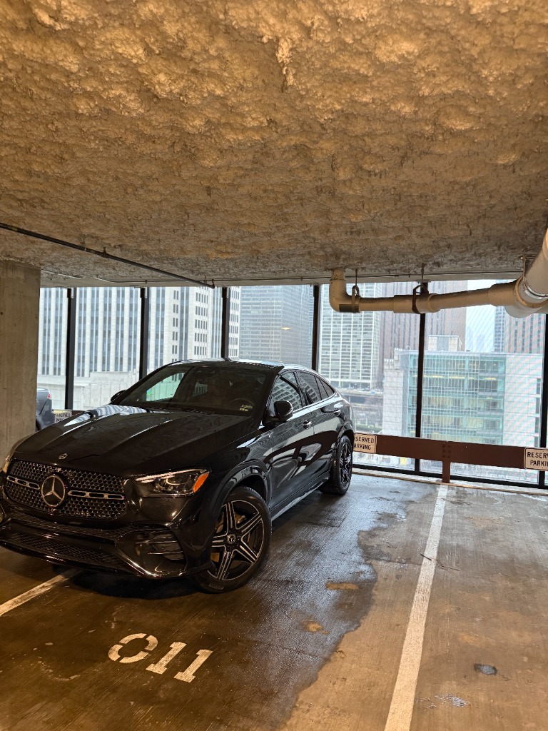 Black Mercedes GLC AMG mobile detailing Chicago downtown parking garage with skyline